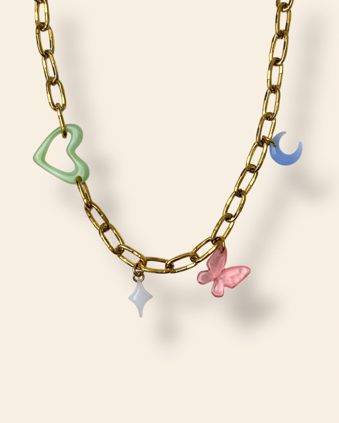 Collier gros maillons quatre charms fond beige