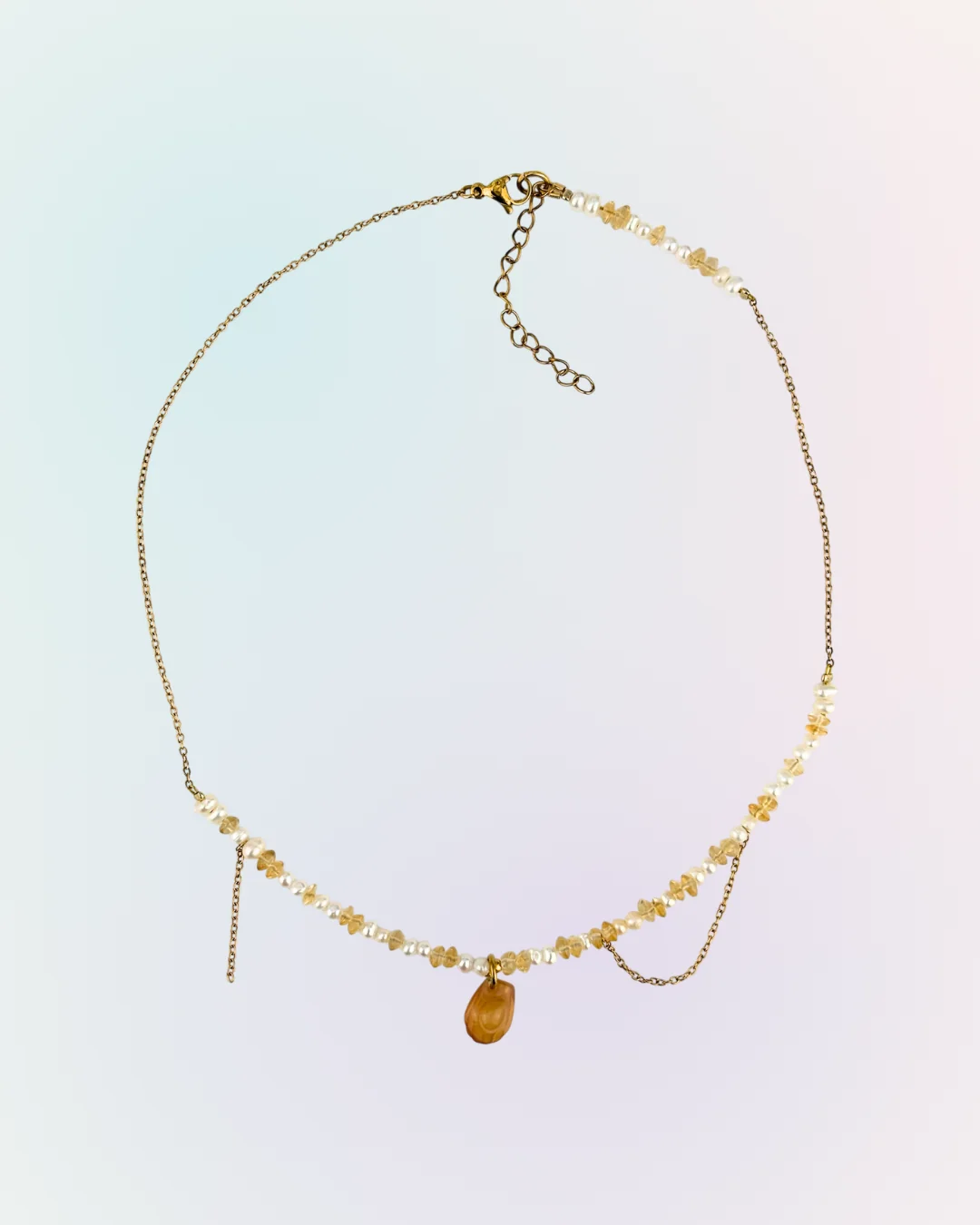 Collier Madeleine doré présenté à plat : perles d'eau douce, citrine, chaîne en drapé et charm madeleine couleur miel, collection Remember October Odyssée Bijoux